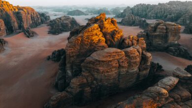an aerial view of a desert with rocks and sand