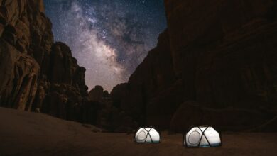 two tents set up in the desert under a night sky